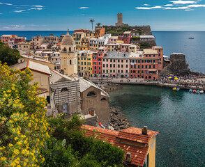 The town of Vernazza with the bell tower of church of Santa Margherita d'Antiochia as it seen from the Azure Trail. - obrazy, fototapety, plakaty