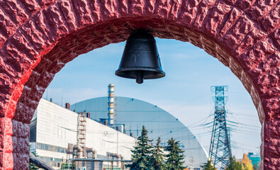 church bell on the background of the nuclear power plant in Chernobyl - obrazy, fototapety, plakaty