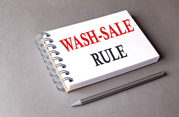 WASH SALE RULE word on notebook on grey background