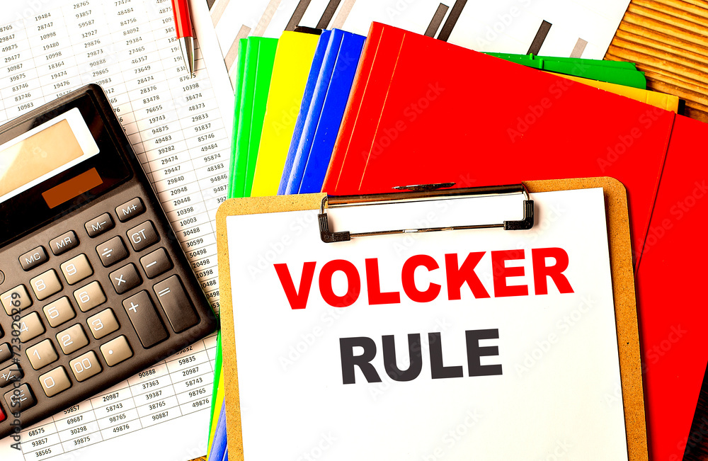 Aufkleber volcker rule text written on paper clipboard with chart and calculator