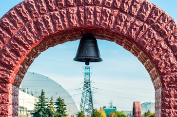 church bell on the background of the nuclear power plant in Chernobyl - obrazy, fototapety, plakaty