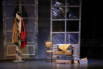  suitcases and wooden chair decoration on the theater stage.