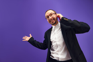 Excited man in glasses and yarmulke emotionally talking on phone, greeting with holiday against...