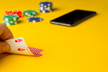 Poker chips and playing cards on colorful background
