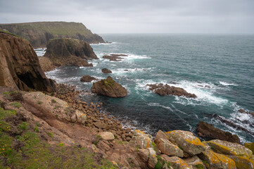 Cornwall's rugged north coast with rough seas at Land's End in Celtic Sea, Penzance, Cornwall. 