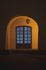 Illuminated Arcades of a medieval building, in the old city center of Sibiu. Warm and cold light. Night view of beautiful estate of Sibiu’s historic center, Romania. Night image of the old house.
