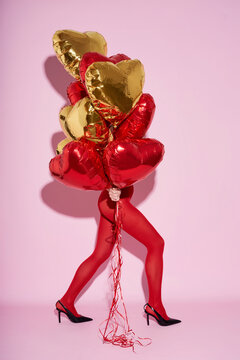 Women wearing stocking holding balloons