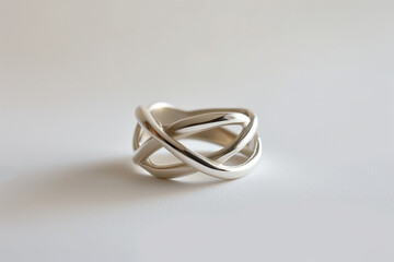 Elegant Silver Infinity Knot Ring on a Soft White Background - Perfect for Jewelry Catalogs and Romantic Occasions