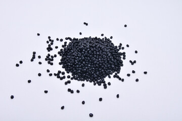 black masterbatch granules isolated on a white background, this polymer is a colorant for products...