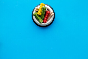Bowl full of chew bones for dog. Food and treats for pets