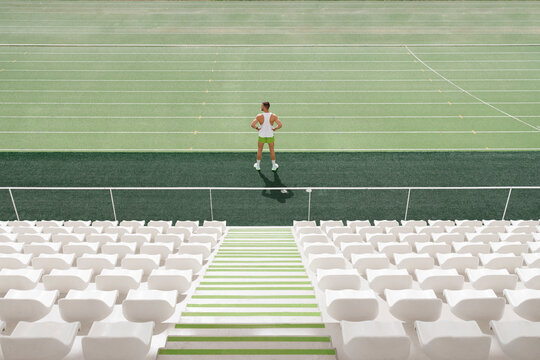 Sportsman standing on running track