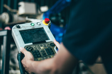 Technician Operating Control Panel for Factory Robot.