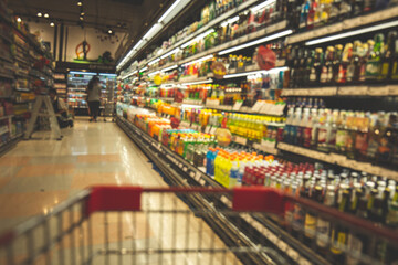 Defocused blur put on the at alcohol drink products in supermarket
