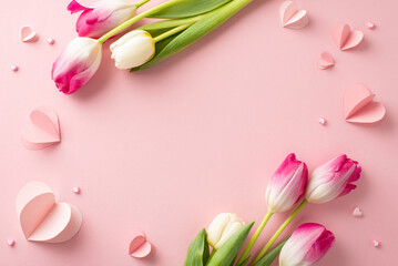 Tulip whispers: Overhead view of enchanting tulips and heart-shaped accents on a soothing pink backdrop. A romantic choice for conveying emotions or featuring promotional content