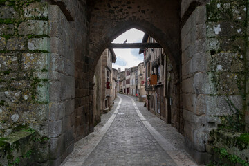 View of the middle street through the Porte Saint-Jacques. Parthenay, France.