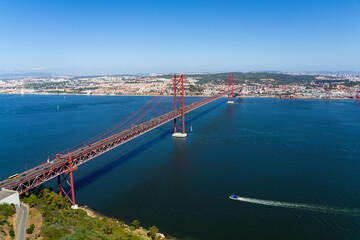 Fototapeta na wymiar Aerial view of April 25th bridge crossing the Tagus river in Lisbon, Portugal.