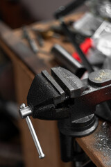 Small locksmith vices, clamps, for small household works. Workshop. Vertical photo. Tools. Selective focus