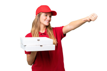 Young caucasian pizza delivery woman with work uniform picking up pizza boxes over isolated...