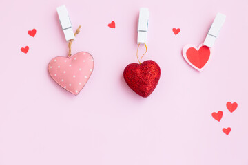 Red and pink heart with white wooden clothespin on pink background, Steel heart, Glitter heart and...