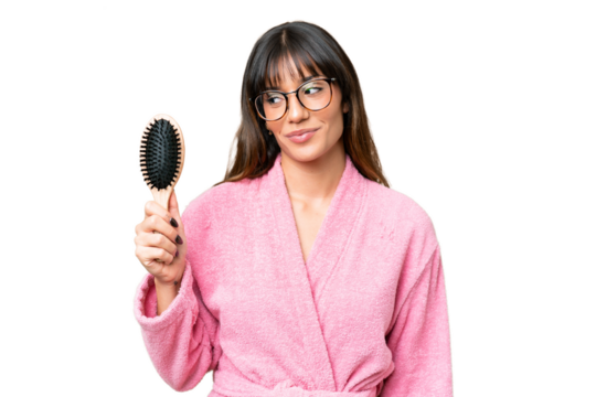 Young woman with hair comb over isolated chroma key background with happy expression