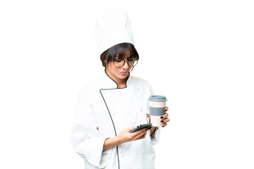 Young caucasian chef  woman over isolated chroma key background holding coffee to take away and a mobile