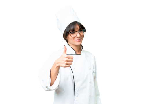 Young caucasian chef  woman over isolated chroma key background with thumbs up because something good has happened