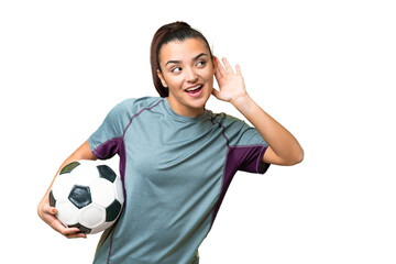 Young football player Woman over isolated chroma key background listening to something by putting hand on the ear - Powered by Adobe