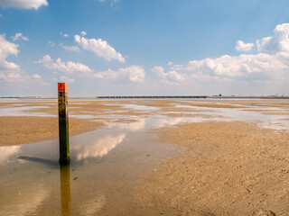 Beach pole with red top in Slijkgat near Haringvlietdam, South Holland, Netherlands