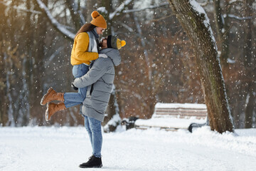 Fototapeta na wymiar Beautiful happy couple outdoors on winter day. Space for text