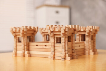Fototapeta na wymiar Wooden fortress on table indoors. Children's toy