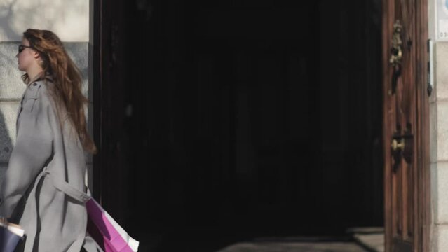 A fashionable, funny girl fooling around and poses for the camera. Fashion, style, clothes, shopping, shopping, money, wealth, success, playfulness, cool mood, audacity