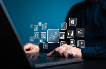 Analyst works on laptop computer to calculate KPI metrics reports with database connected. Data...