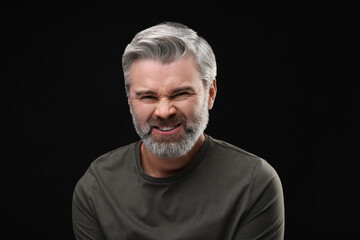 Personality concept. Portrait of emotional man on black background