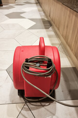 Close-up of portable floor dryer fan used in public washroom and toilet to dry the floor after washing and cleaning