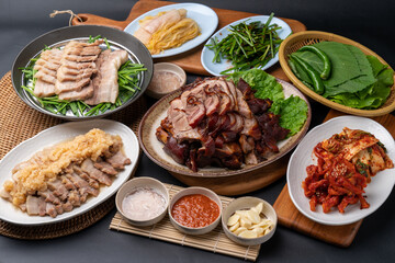 Korean food, bossam, boiled pork, pig feet, steamed pork feet, side dishes, lettuce, garlic bossam, perilla leaves, chives, kimchi