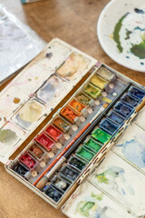 Watercolor paint palette in the artist's work