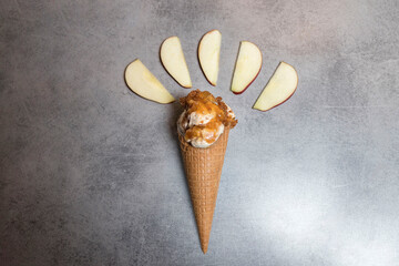 Top view of a cone with apple pie ice cream and apples. soft view