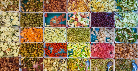 Top view of assorted fruits and pickled fruits on trays for sale in street market, healthy food concept Include high vitamin fruits, fresh fruits, Thai fruits, Street food.Variety fruits as background
