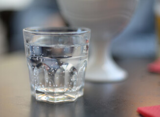 Generic glass filled with sparkling mineral water. Selective focus