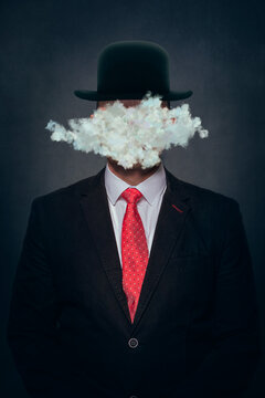 Cloud covering face of man wearing hat against black background