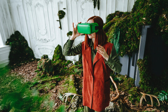Redhead woman wearing virtual reality simulator