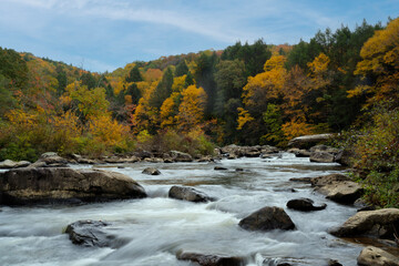 Looking up stream on the Big Sandy River colorful fall scenes with green and yellows