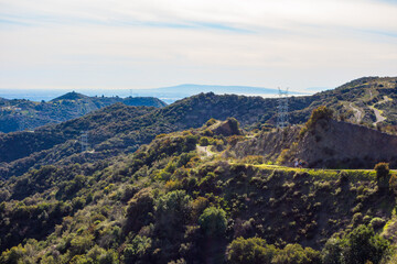 Views of the winding Westridge trail coming up the Santa Monica Mountains with the pacific ocean in...
