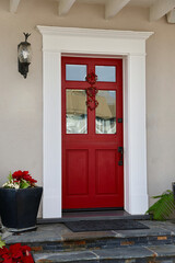 Fototapeta premium Bright red front door with white wood moulding