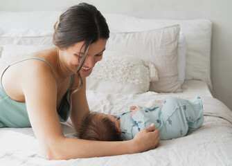 newborn baby with mother on the bed