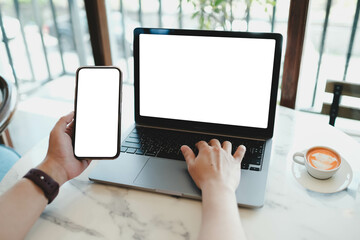 A white blank screen for hand typing text,using laptop and mobile phone contact business searching...