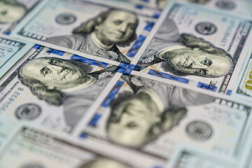 Many 100 USD banknotes set with heads of Benjamin Franklin one to another 
