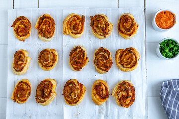 Rolls with puff pastry, pesto and tuna on a white background