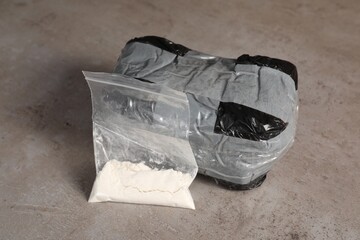 Packages with narcotics on grey textured table