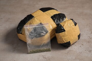 Packages with narcotics on grey textured table